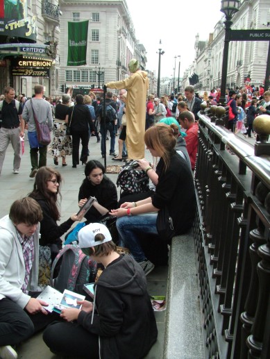 "Floating Yoda" appears among the shoppers and visitors in Piccadilly Circus 