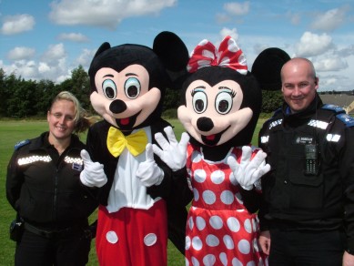 Mickey and Minnie Mouse join forces with officers from the South Moor Neighbourhood Police Team during the  recent Family Fun Day