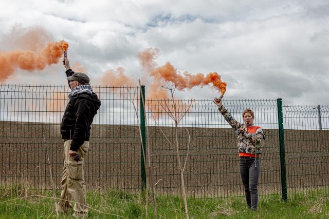 In Consett, County Durham, a protester lights a flare at Hassockfield, highlighting the urgent call for reform in immigration detention practices.