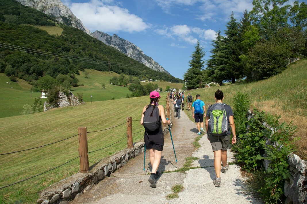 A group of hikers walking a scenic mountain trail on a historic pilgrimage route in Spain