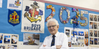 Lanchester Local Eric Hepplewhite Celebrated for Lifelong Community Impact Eric Hepplewhite standing in front of Boys Brigade display in Lanchester