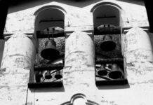 The Bells Monochrome photograph looking up into an old bell tower, showing several large cast bells hanging in their frame