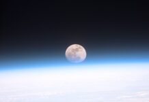 The Moon The full moon seen from orbit, sitting just above the blue curve of Earth's atmosphere with dark space above and cloud below